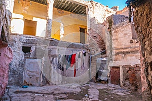 Pink Moroccan facade in City center. Window with drying hanging clothe. Ruins, Poor district. devastation. Lifestyle. In