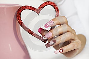 Pink multicolored manicure on long nails.