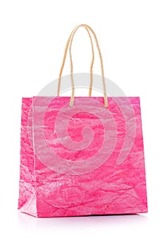 Pink nacre gift bag with raised handles. Isolated on a white background.