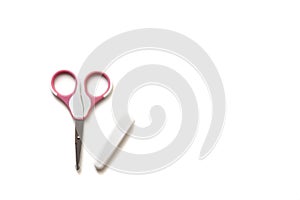 Pink nail clippers with a white cap for cutting children`s nails on a white background, children`s manicure.