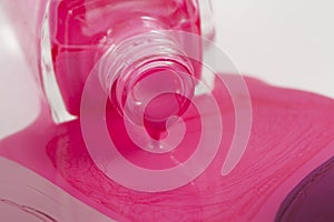 pink nail polish bottle with splatters isolated