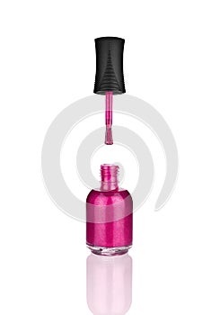 Pink nail polish glass bottle, brush & mirror reflection white background isolated closeup, open varnish package & shadow, lacquer