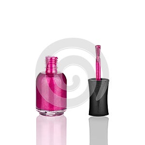 Pink nail polish glass bottle, brush & mirror reflection white background isolated closeup, open varnish package & shadow, lacquer