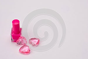 Pink nail polish with glass hearts of pink color