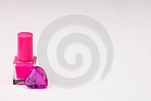 Pink nail polish with glass hearts of violet color