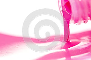 Pink Nail polish spill isolated on white background close up