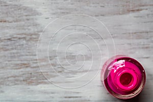 Pink nail polish on white background