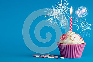 Pink new years cupcake with candle