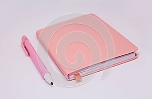 Pink note pad and pencil, soft focus. Notebook, organizer, diary for planning, memo or sketching