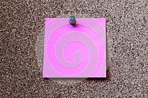 Pink note paper pin on the cork board