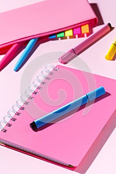 Pink notebook with marker on the background of the pencil case