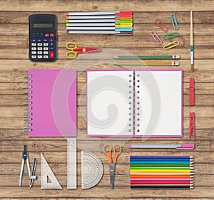 Pink notebook and school or office tools on wood background