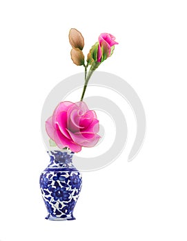 Pink nylon fabric flower in blue ceramic vase on isolate white background