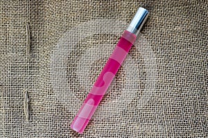 Pink oblong long thin beautiful glass matte fashionable glamorous bottle of cologne, perfume with silver cap and place for sample