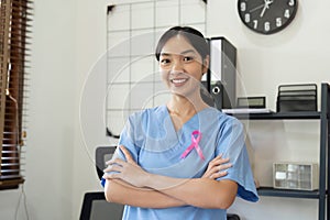 Pink October Breast Cancer Awareness month, doctor with pink ribbon symbol. National cancer survivors month. health care