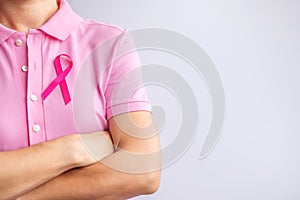 Pink October Breast Cancer Awareness month, woman hand hold pink Ribbon and wear shirt for support people life and illness.