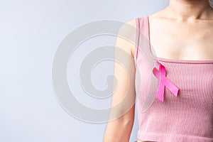 Pink October Breast Cancer Awareness month, woman hand hold pink Ribbon and wear shirt for support people life and illness.