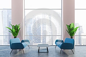 Pink office lounge area, blue sofas