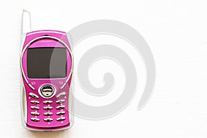 Pink older little mobile phone press the button old generation