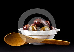 Pink olives in a white bowl