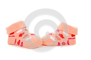 Pink orange baby socks with hearts on a white backgroun