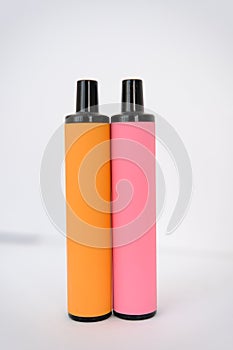 pink and orange disposable electronic cigarettes on white background. Copy space