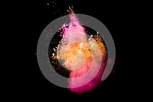 Pink orange dust particles splash on white background.Colorful powder splash