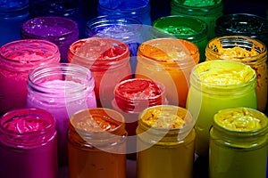 pink orange and yellow colors of screen printing ink for print on tee shirts and fabric.