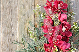 Pink Orchid Cymbidium Flowers Bouquet on Old Wood Planks