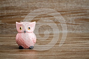 Pink Owl Figurine on Wooden Background