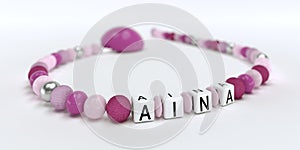 A pink pacifier chain for girls with name Aina