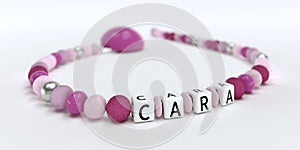 A pink pacifier chain for girls with name Cara