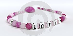 A pink pacifier chain for girls with name Lotta