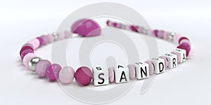 A pink pacifier chain for girls with name Sandra