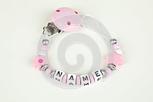 A pink pacifier chain