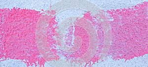 Pink paint strokes and smudges on an old light blue wall background. Abstract urban banner background