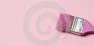 Pink paintbrush with pink paint, banner format