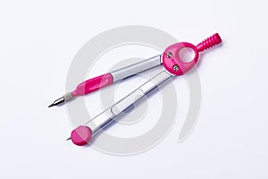 Pink pair of drawing compasses.