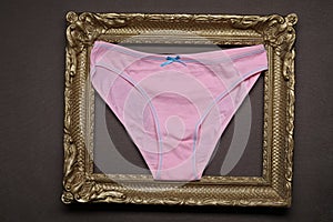 Pink panties in a wooden photo frame