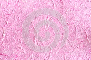 Pink paper background with fiber structure.