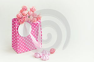 Pink paper bag with bouquet of roses, holiday gift card