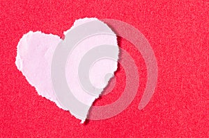 Pink paper heart on redbackground