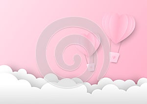 Pink paper heart shape balloon floating in the sky