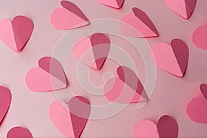 Pink paper hearts on pink background