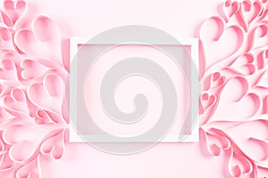 Pink paper hearts with white picture frame on Light pink pastel paper background. Love and Valentine`s day concept