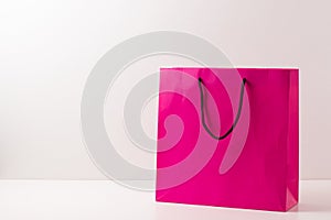 Pink paper shopping bags isolated on white.