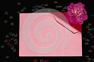 pink paper unrolling under it red paper with pink flower on a black background creative art romantic design