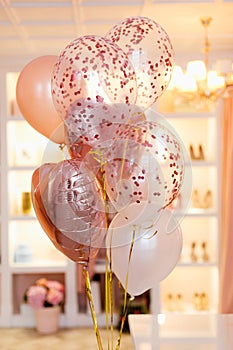 Pink and peach shades of balloons on the background of the dressing room