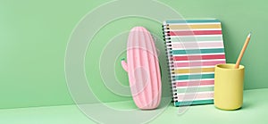 Pink pencil case notepad on green. Back to School