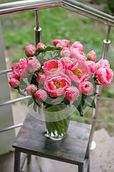 Pink peonies. Beautiful summer bouquet. Floral composition. Wallpaper. Lovely flowers in glass vase.
